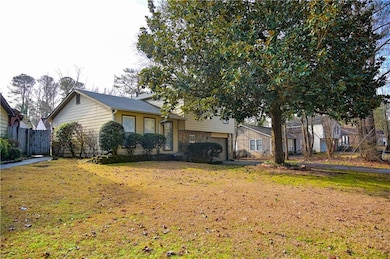 Tri-level home featuring a front yard