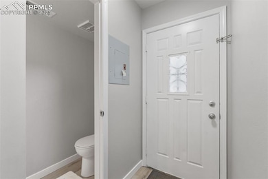 Bathroom featuring electric panel and wood finished floors