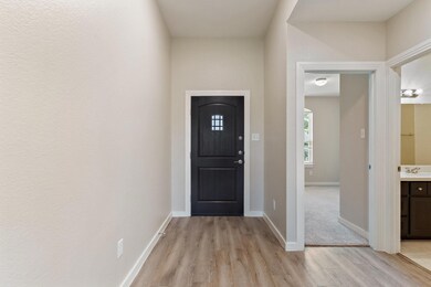 Entryway with sink and light hardwood / wood-style flooring