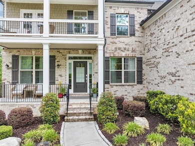 View of exterior entry with covered porch, brick s