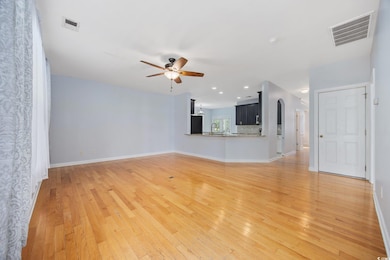 Unfurnished living room featuring a ceiling fan, l