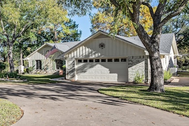 Single story home featuring roof with shingles, brick siding, board and batten siding, and a front yard