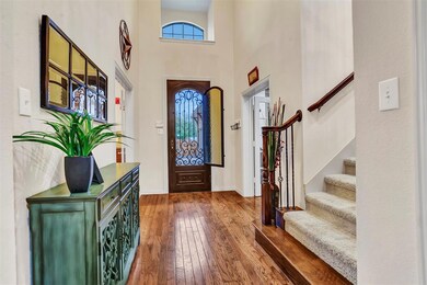 Looking back through the entry to see the impressive wood and wrought iron front door with glass inset that can be opened for added security when visitors are at the door.