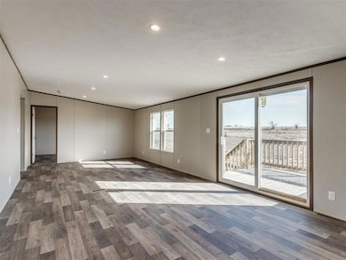Spare room featuring recessed lighting, wood finished floors, ornamental molding, and a textured ceiling