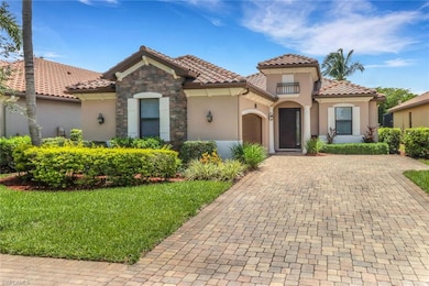 Mediterranean / spanish-style house with stucco siding, a tiled roof, and a front lawn