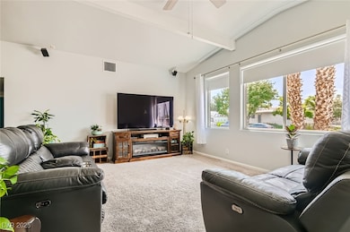 Living room with carpet floors, baseboards, and a