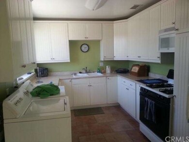 Nice bright kitchen with washer and dryer in kitch