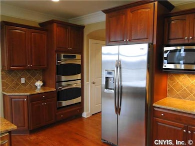 Kitchen Note exhaust fan with cherry cabinet surro