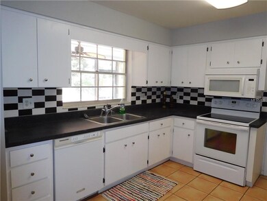 Kitchen with white cabinets and white appliances