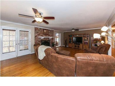 Living room with wood floors & wood burning firepl