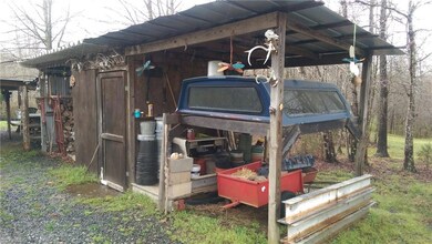One of many shed/covered storage buildings on property.