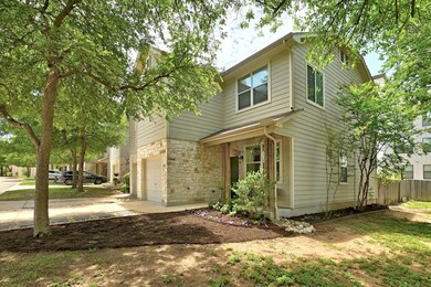 View of front of property featuring a garage, con