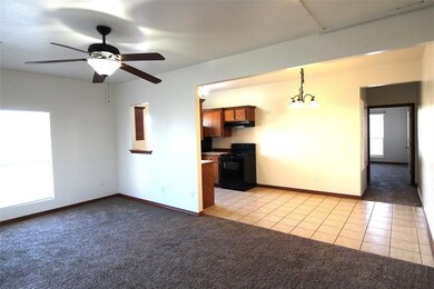 Unfurnished living room featuring light tile floor