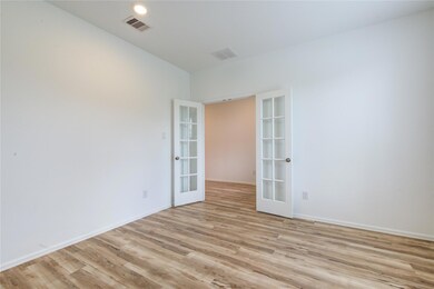 Unfurnished room featuring french doors and light