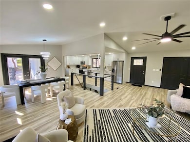 Rec room featuring lofted ceiling, light wood finished floors, recessed lighting, and ceiling fan