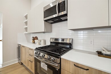 Modern kitchen featuring sleek cabinetry, stainles