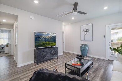 Living area with wood finished floors, ceiling fa
