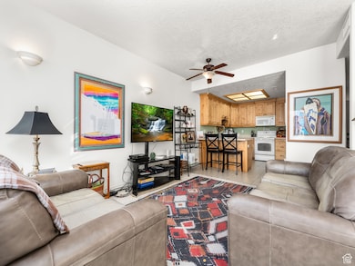 Living room featuring a textured ceiling and a ceiling fan