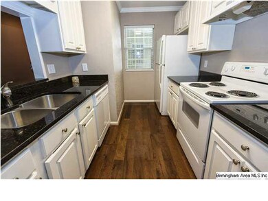 Kitchen with white cabinetry, granite counters, ha
