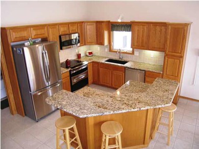 A view of the updated kitchen with slab granite co