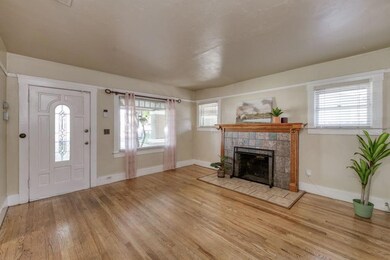 Hardwood flooring and a fireplace with mantle