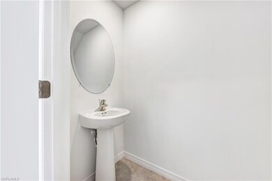 Bathroom with baseboards and tile patterned flooring
