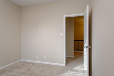Unfurnished room with light carpet and baseboards