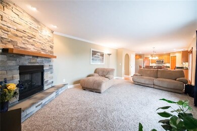 Grand stone gas fireplace located in the first flo