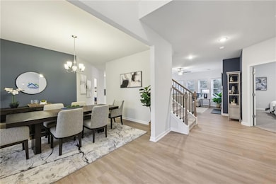 Dining room with wood finished floors, stairway, a