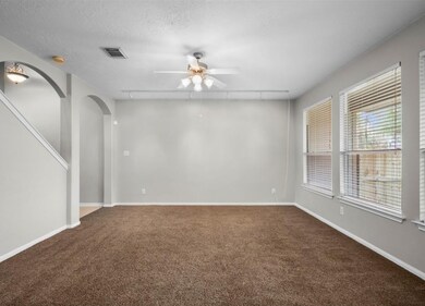 Spacious living room with ample natural light, coz