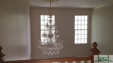 View of 2 story foyer from upper stairway landing