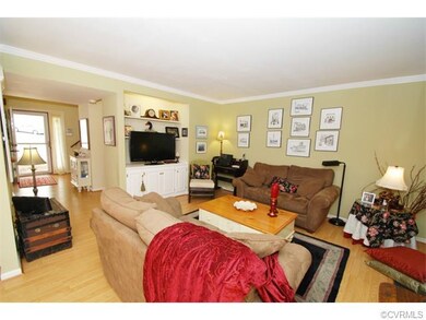 The Living Area Features Crown Moulding and an Ent