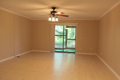 Tiled great room opens to screened porch