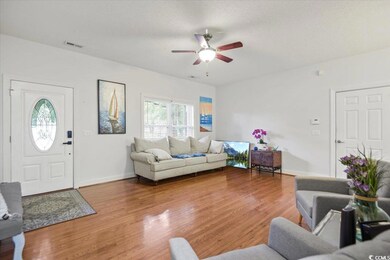 Living room with a textured ceiling, ceiling fan, 