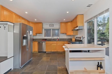 Kitchen in upper, larger unit