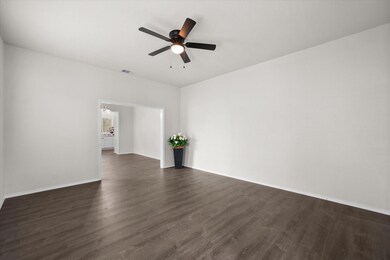 Unfurnished room featuring ceiling fan and dark wood-type flooring