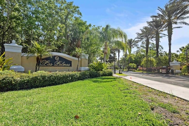 Community / neighborhood sign with a yard and view of scattered trees