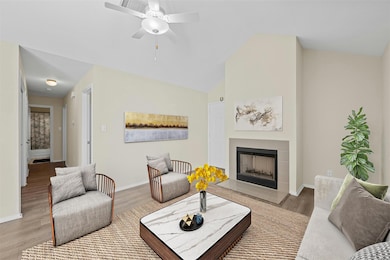 Living room featuring vaulted ceiling, a fireplac