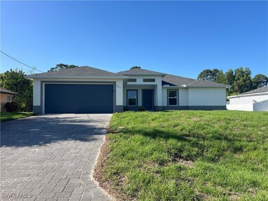View of front of house featuring a garage, stucco