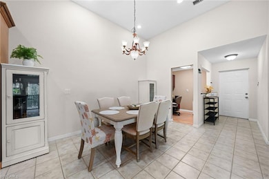 Tiled dining room with a notable chandelier and a 