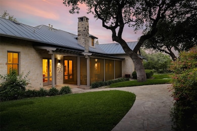Back of property featuring a standing seam roof, 
