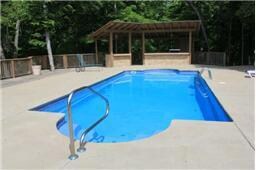 Pool is an in ground granite pool with a Tiki Bar complete with the grill and sink. Lots of patio space to decorate and entertain with. Pool has a self cleaning system. Enjoy!