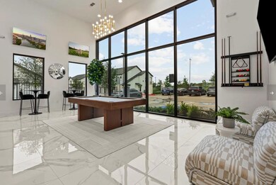 Recreation room with a high ceiling, light marble