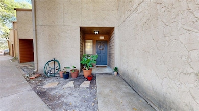 Entrance to property with stucco siding