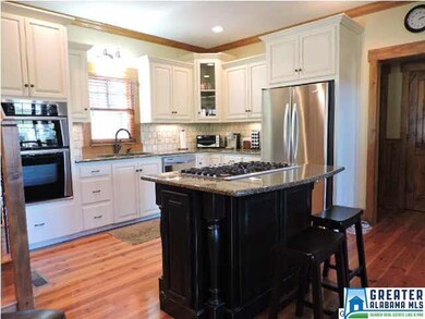 Kitchen has stainless appliances and island with 5