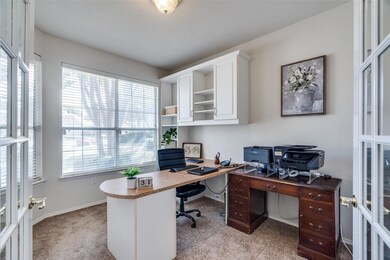Office up front with french doors and light carpet