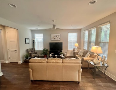 Living room featuring baseboards, dark wood-style