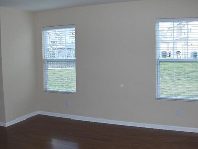 Livinig area is bright and cheerful. Windows include blinds.