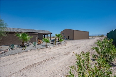 View of yard featuring a detached garage and an ou