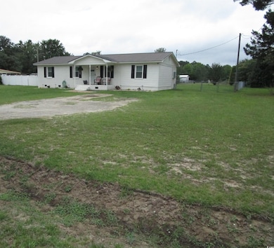 Single story home with covered porch and metal roof